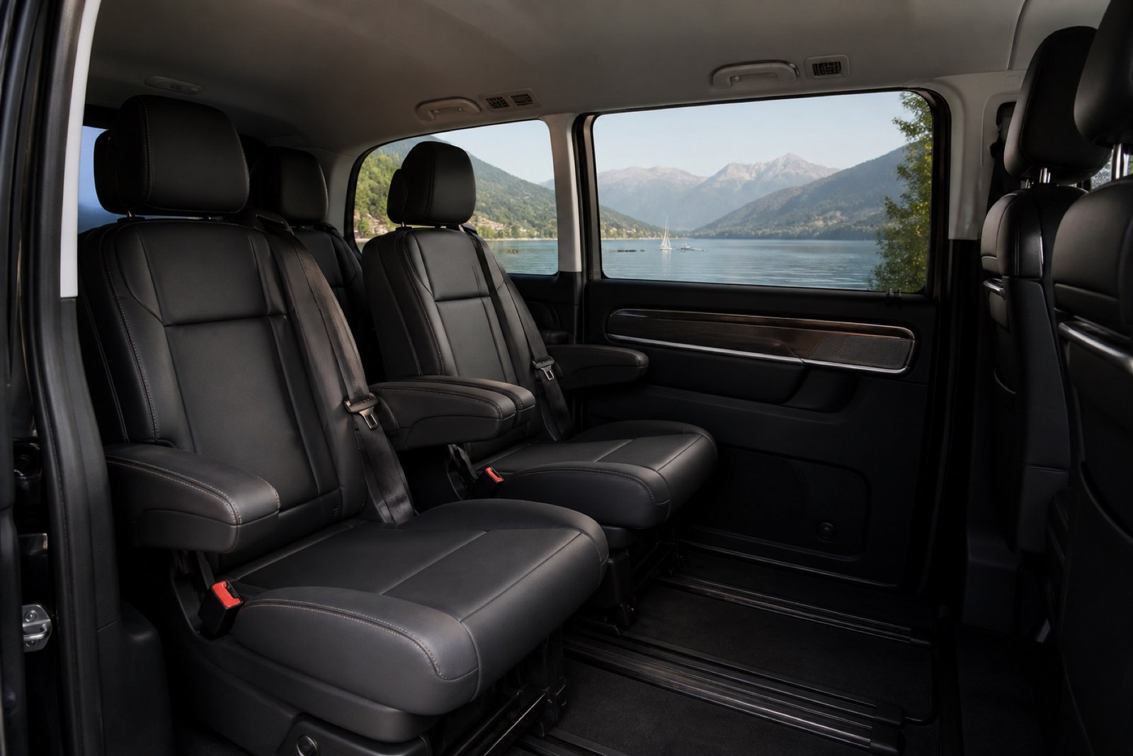 Empty leather seats inside a minivan with a lake view